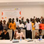 A group of people sign to the camera at the launch of the South Sudan Sign Language Training Centre.